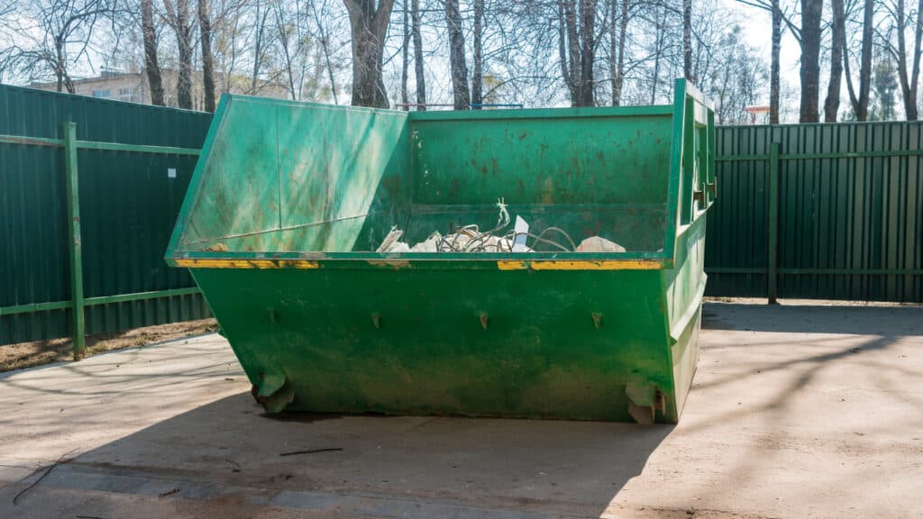 Open street dumpster is deposit or dispose of garbage waste or unwanted material typically in a careless or hurried way.