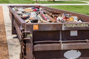 waste dumpster full of household junk