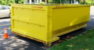yellow dumpster on street