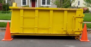 Yellow dumpster in front of home