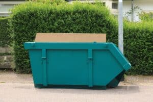 Loaded dumpster near a home